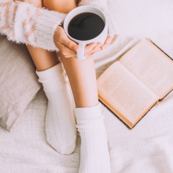 woman holding coffee cup wearing cozy socks
